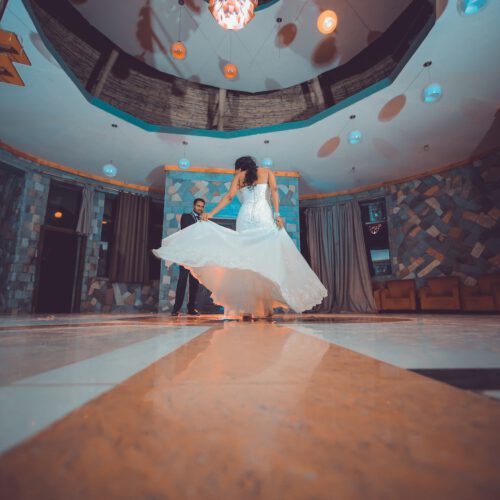 woman in white dancing in a ballroom